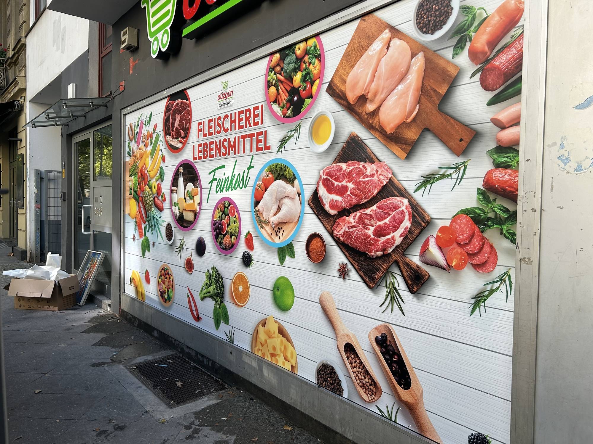 Facade graphics “Fleischerei – Lebensmittel – Feinkost” with meat, vegetables and spices